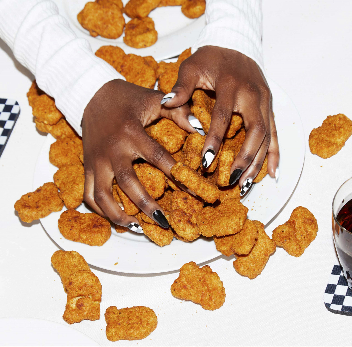 a woman holding a plate of chicken nuggies