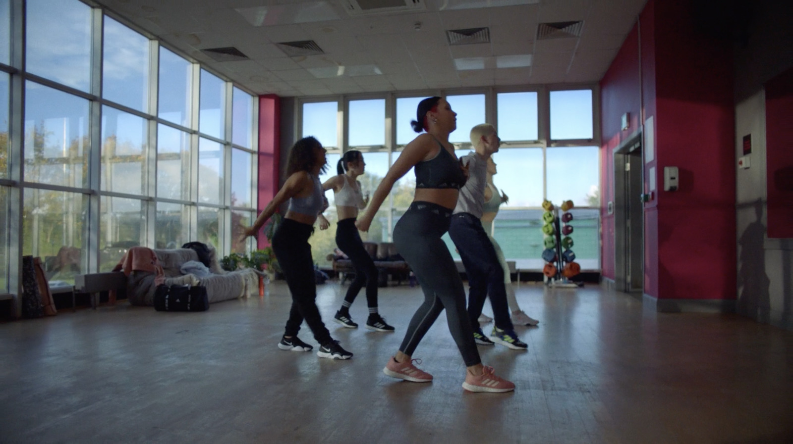 a group of young women dancing in a dance studio