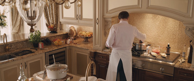 a woman standing in a kitchen preparing food