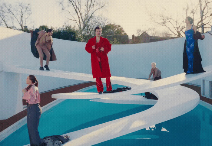 a group of people standing around a pool