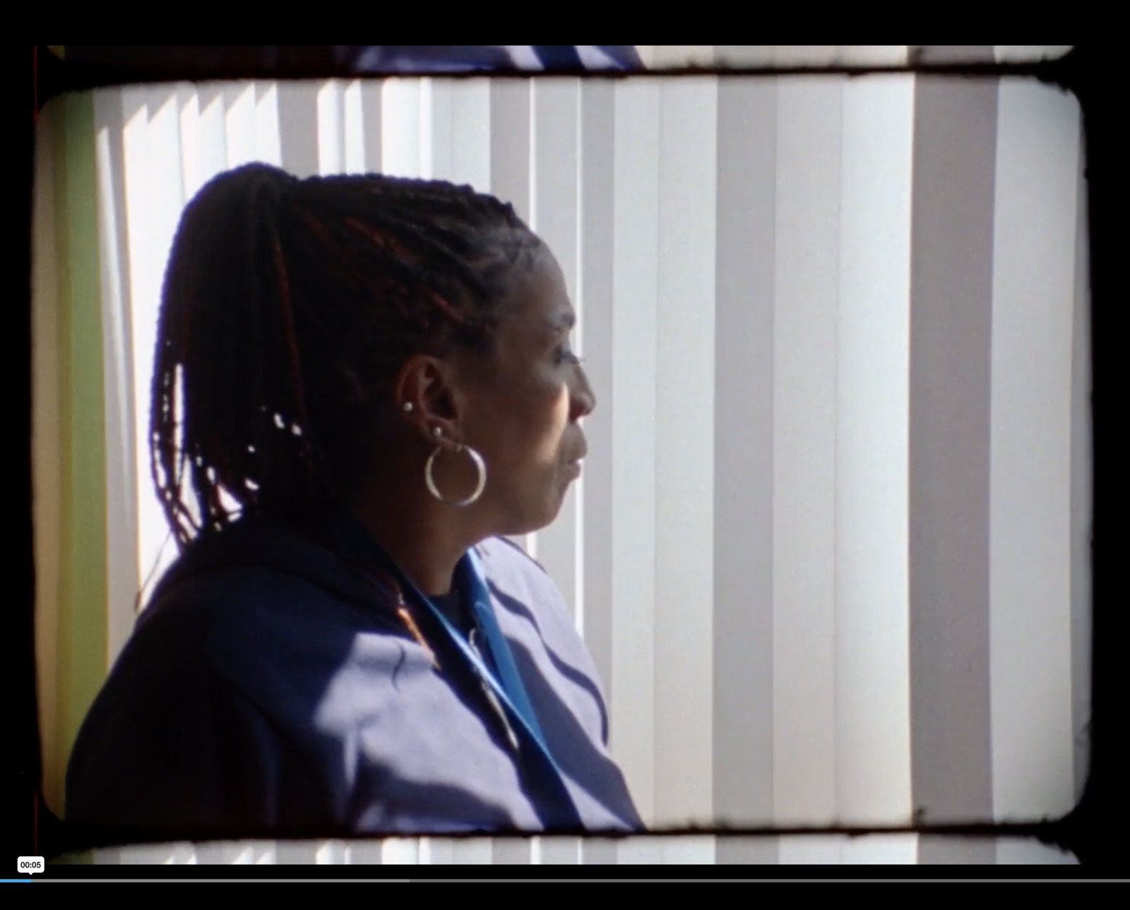 a woman standing in front of a window