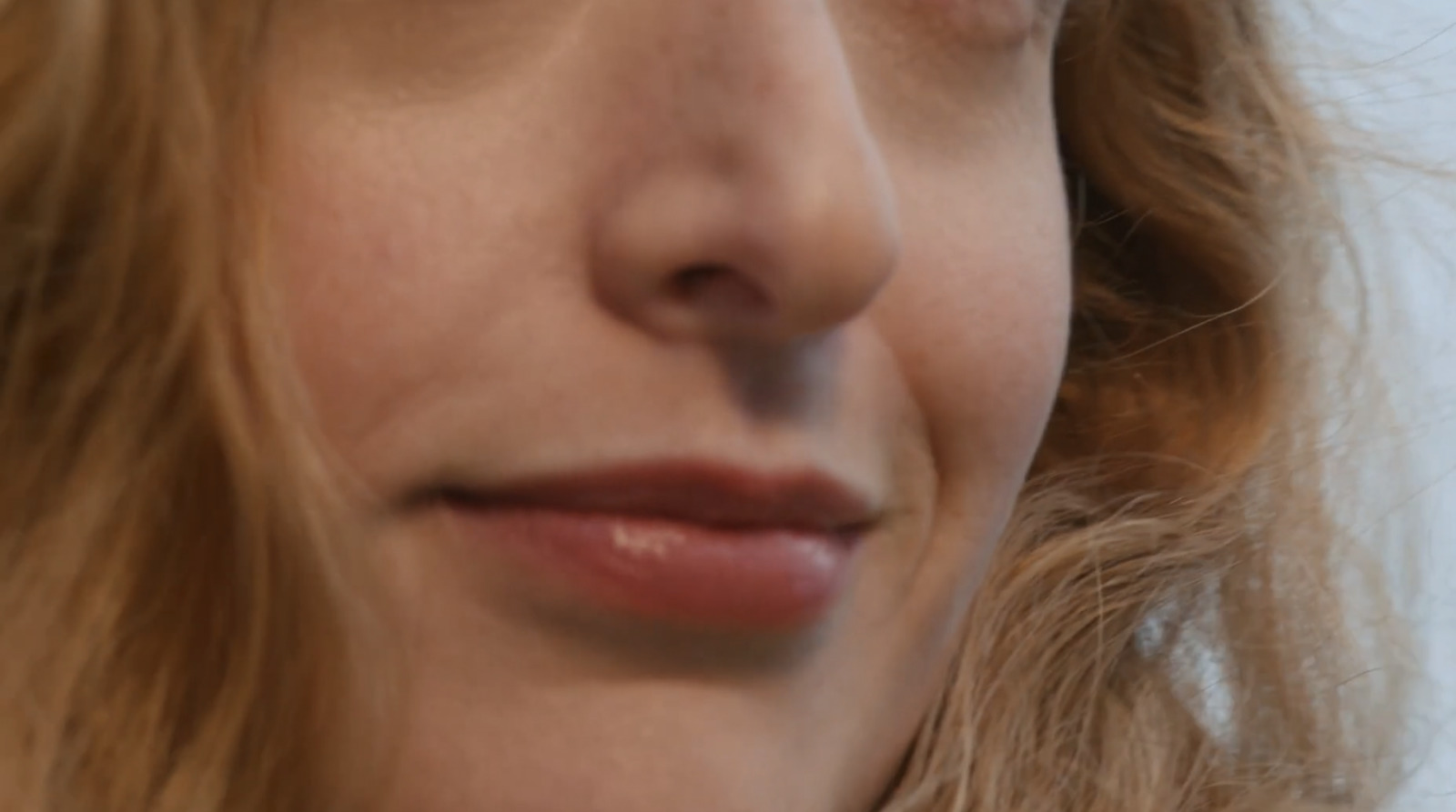 a close up of a woman's face with a toothbrush in her mouth