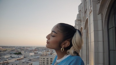 a woman looking out of a window at a city