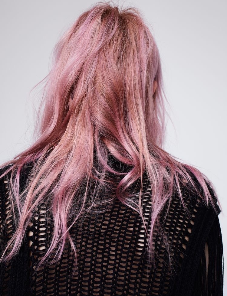 the back of a woman with pink hair