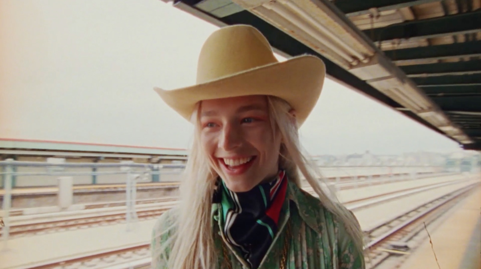 a woman with long white hair wearing a cowboy hat