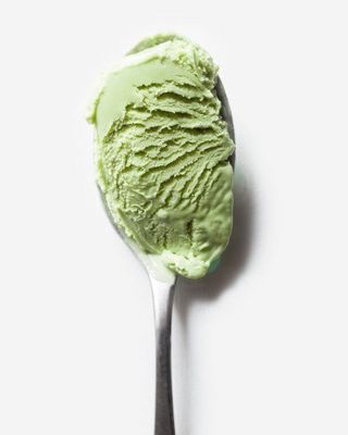 a spoon with a scoop of green ice cream