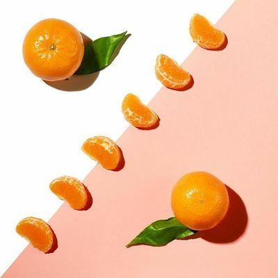 a group of oranges sitting on top of a pink table