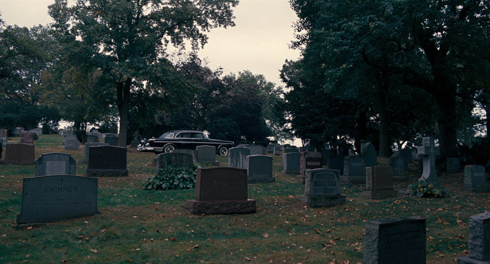 a cemetery with a car parked in it