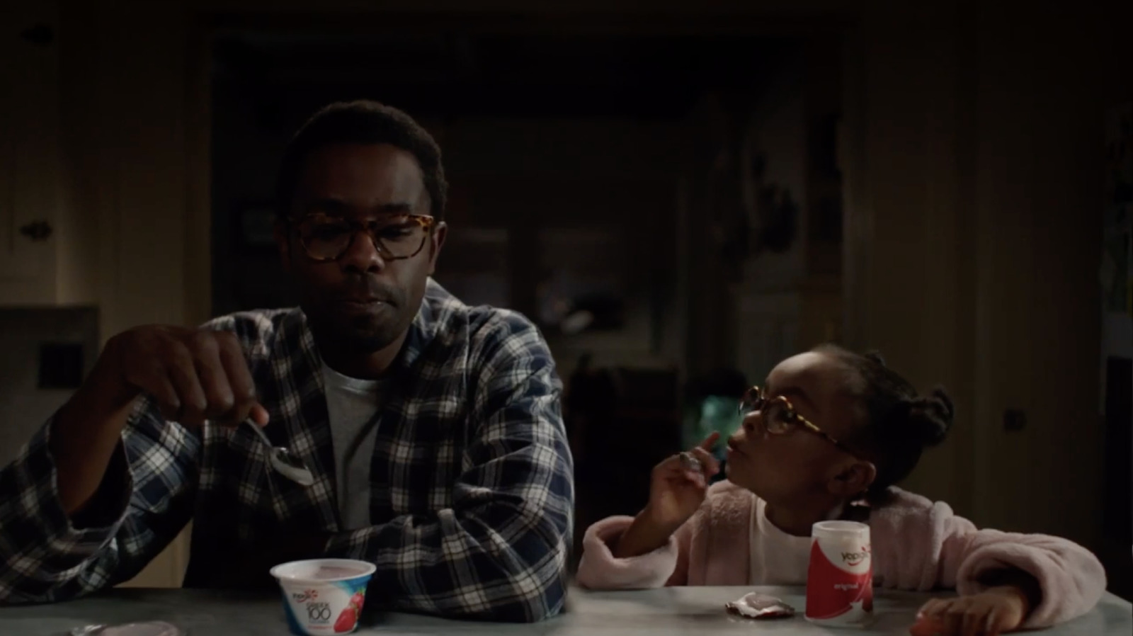 a man and a little girl sitting at a table