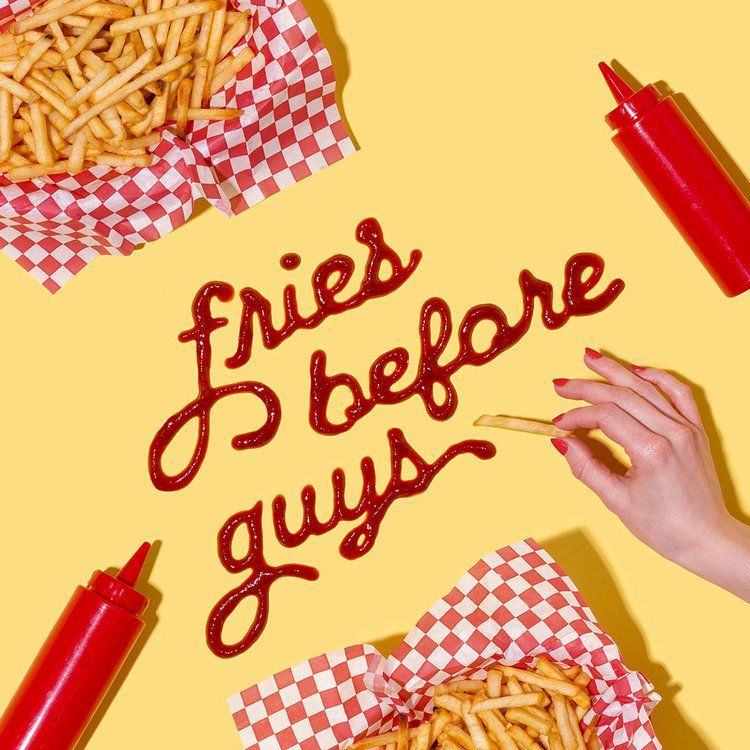 a person is writing fries before guys on a yellow background