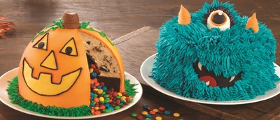 two cakes decorated to look like monsters and pumpkins