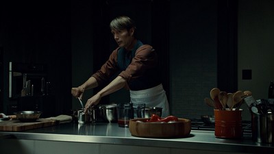 a man standing in a kitchen preparing food