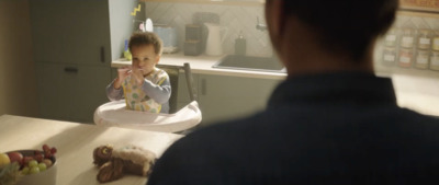 a young child sitting in a high chair in a kitchen