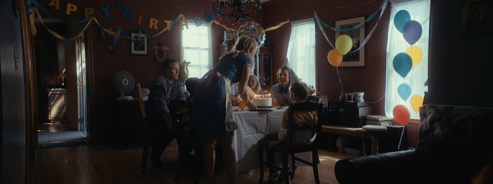 a group of people standing around a table