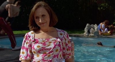 a woman standing in front of a swimming pool