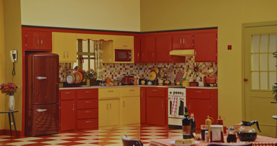 a red and yellow kitchen with a checkered floor