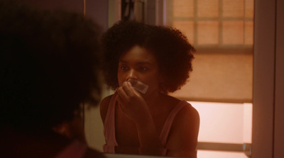 a woman brushing her teeth in front of a mirror