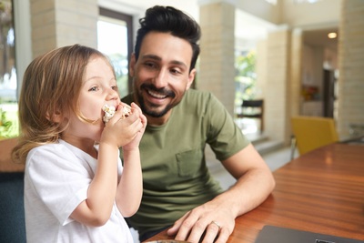 a man and a little girl sitting at a table