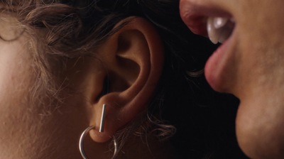 a close up of a person wearing a pair of earrings