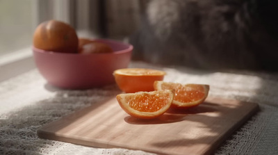 a wooden cutting board topped with sliced oranges