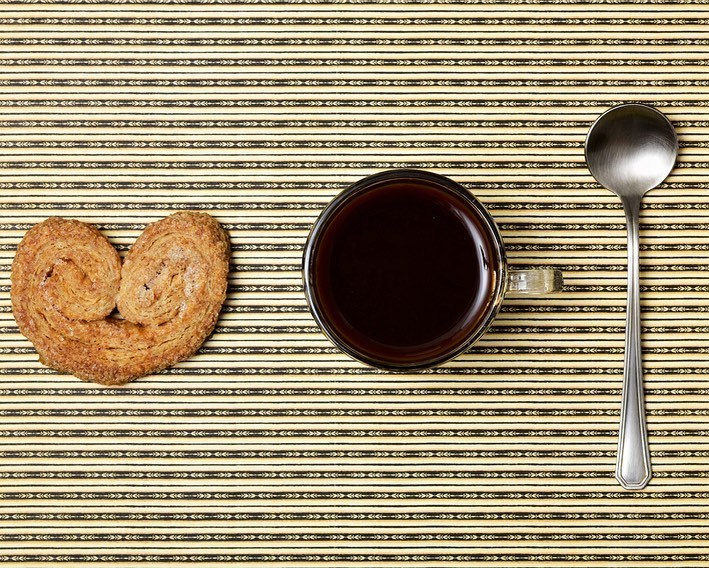 a cup of coffee and some cookies on a table