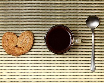 a cup of coffee and some cookies on a table