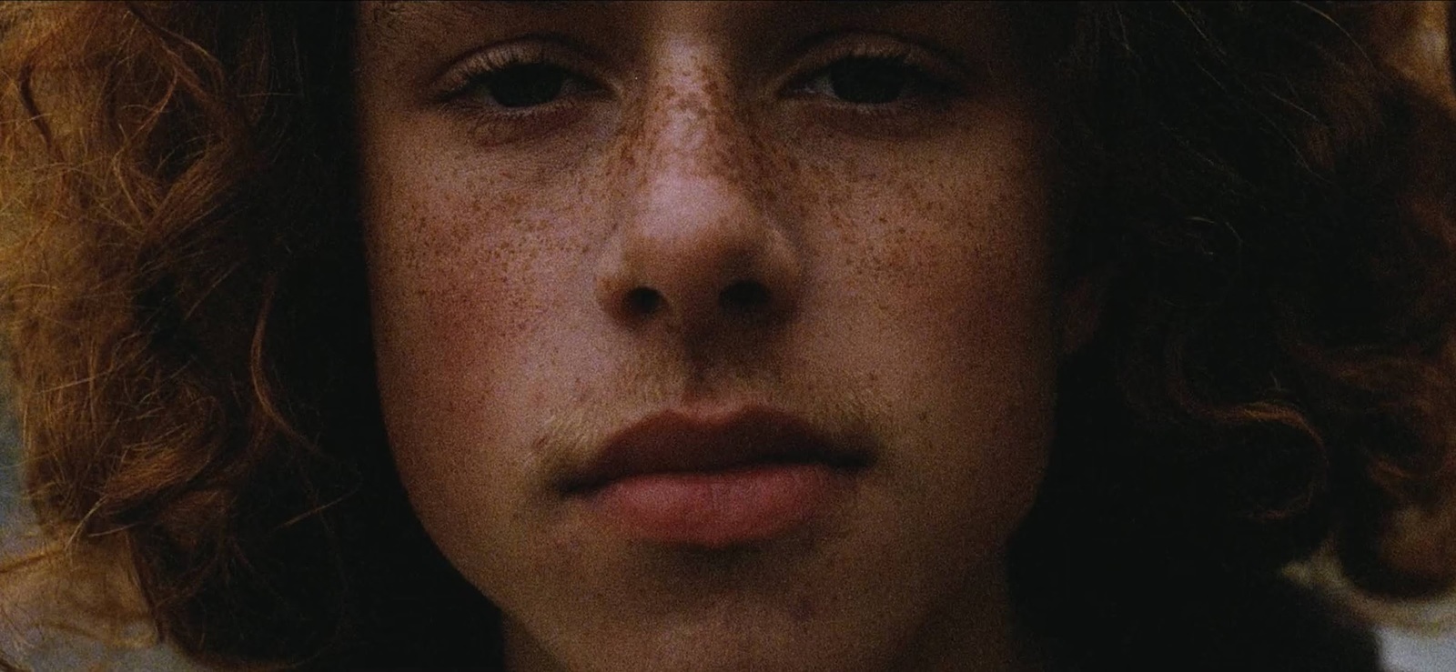 a close up of a person with freckled hair