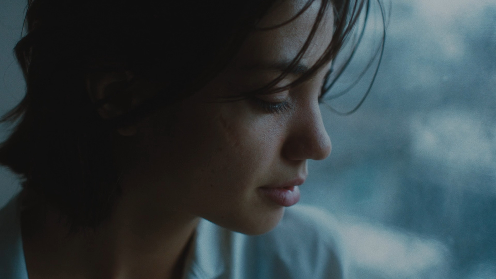 a close up of a person looking out a window