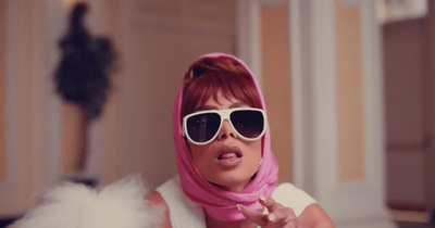 a woman wearing sunglasses and a pink scarf