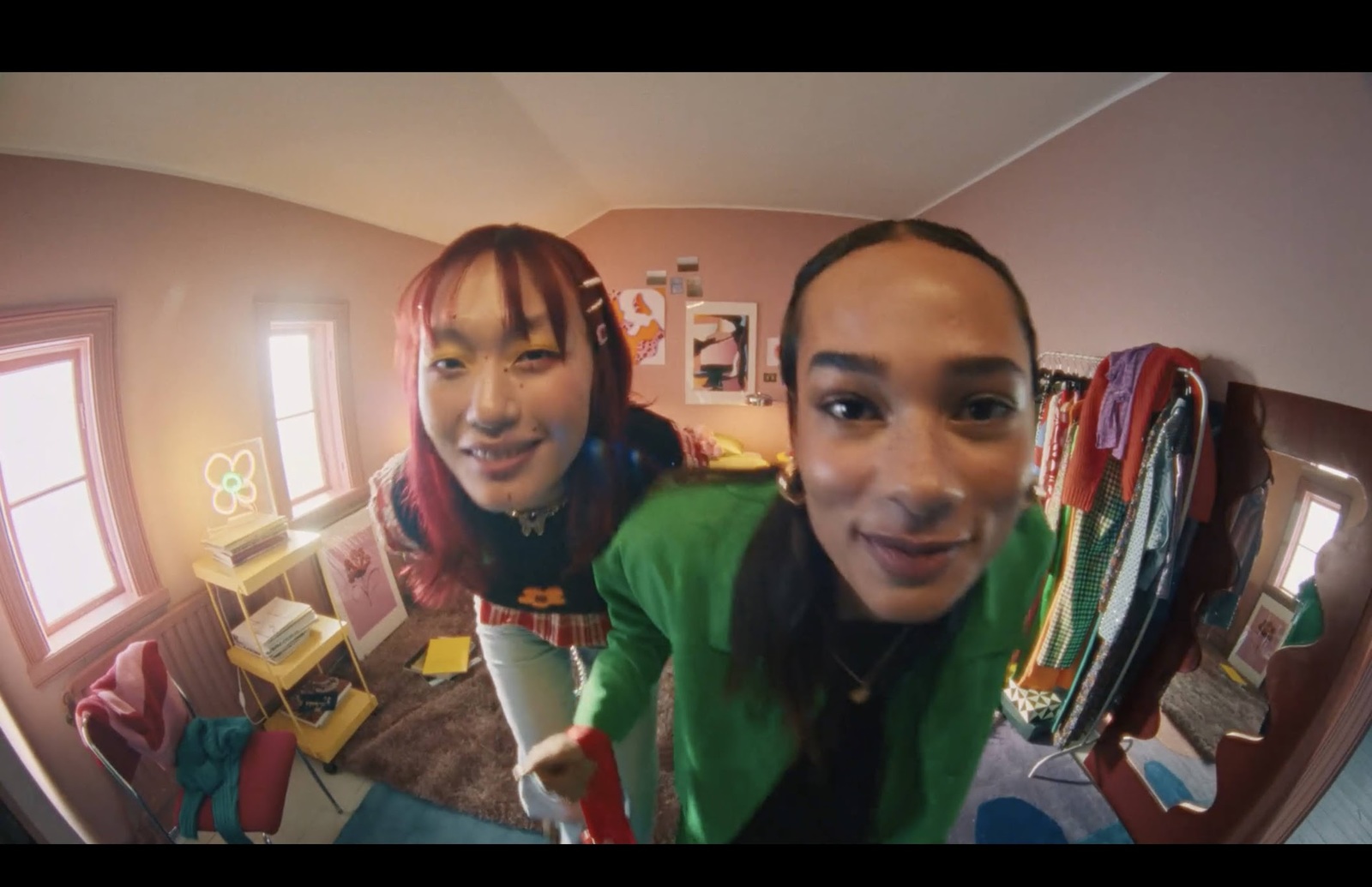 two women are taking a selfie in a mirror