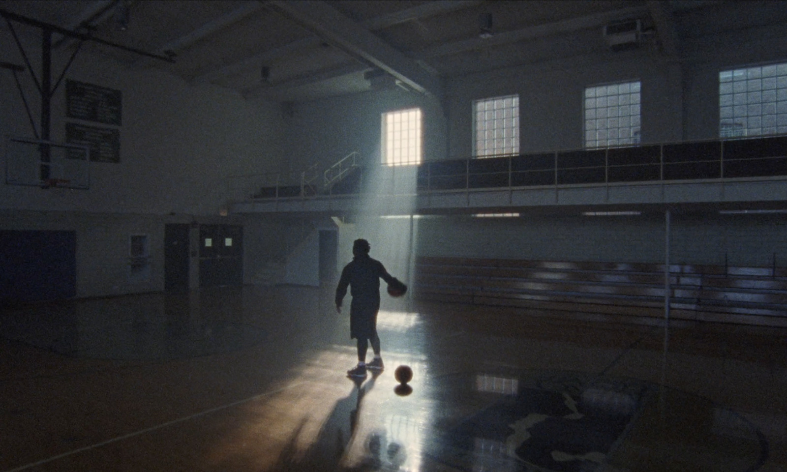 a person standing in a gym with a ball