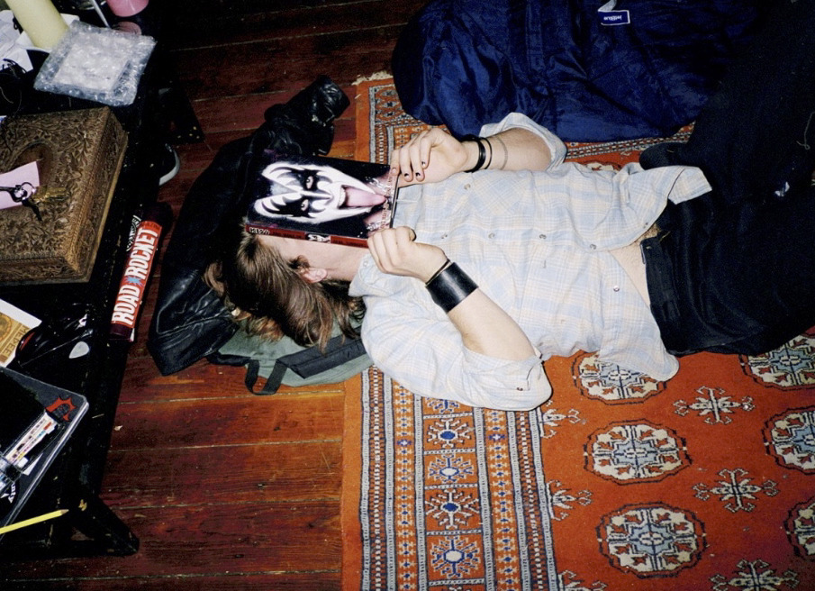 a woman laying on the floor with a hat on her head