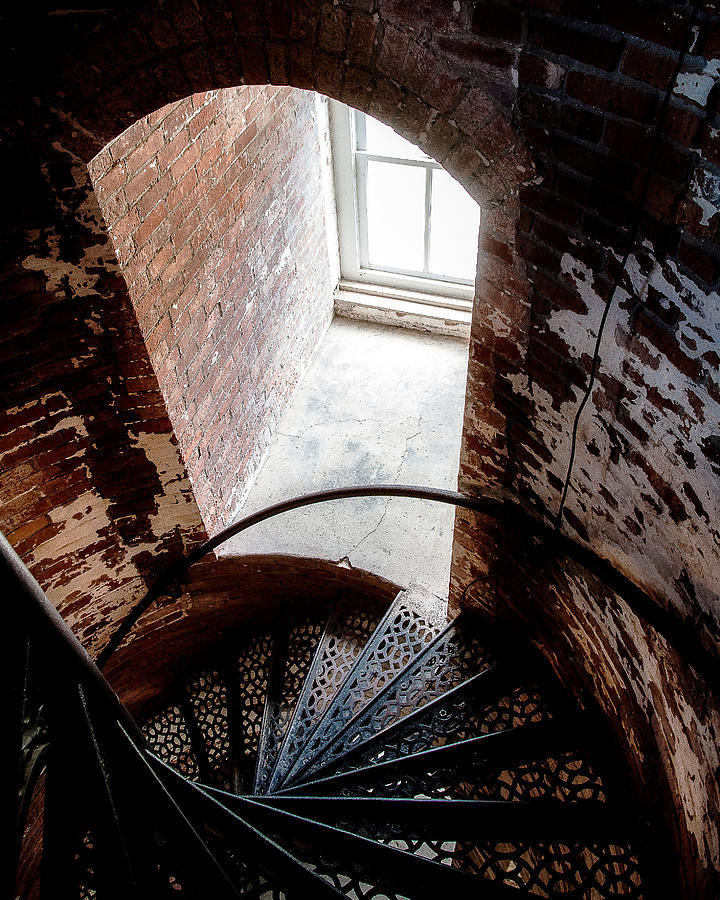 a spiral staircase in an old brick building