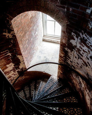 a spiral staircase in an old brick building