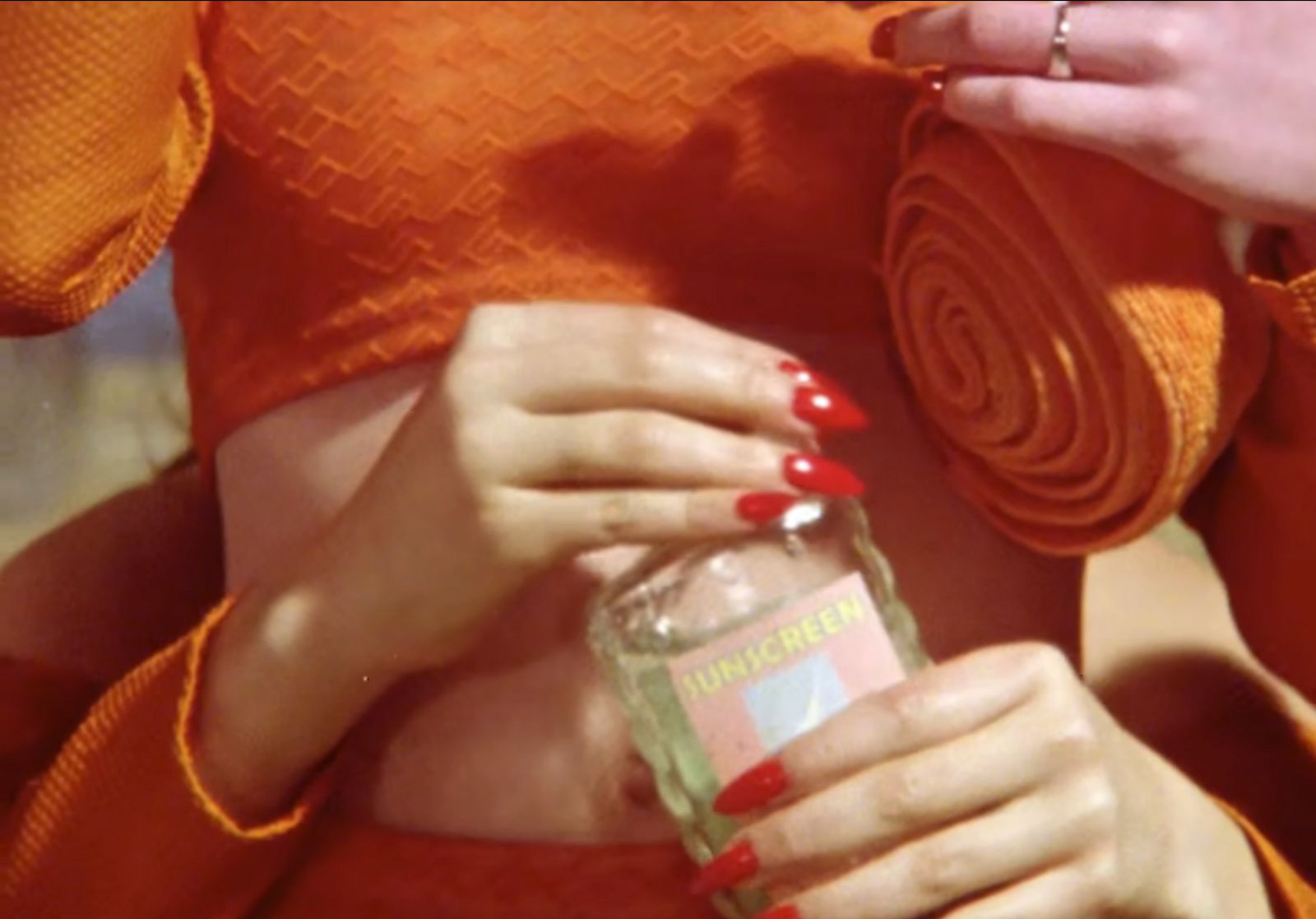 a woman in a red dress holding a bottle of water