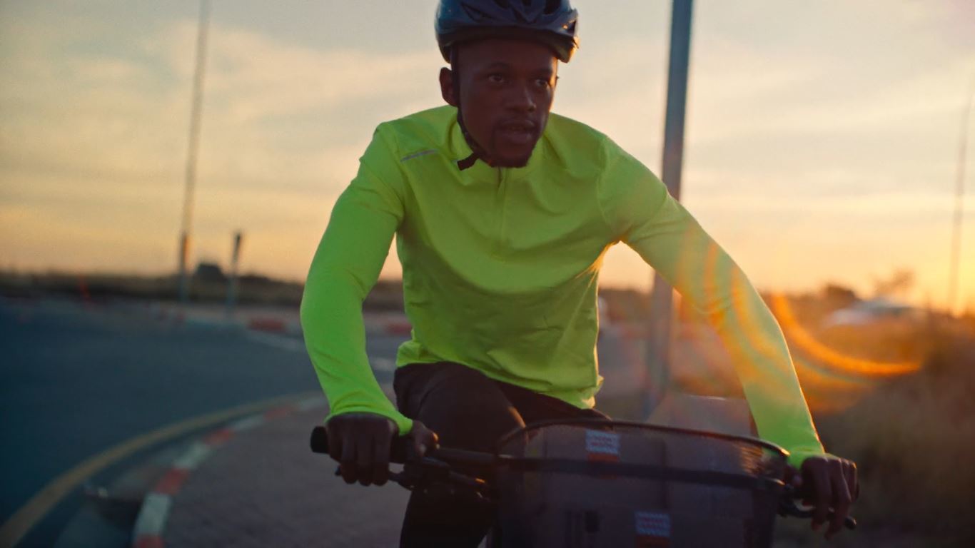 a man riding a bike down a street