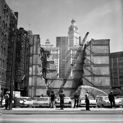 a black and white photo of a fire hydrant on a city street