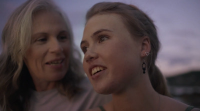 two women standing next to each other smiling