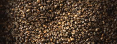 a large pile of coffee beans sitting on top of a table