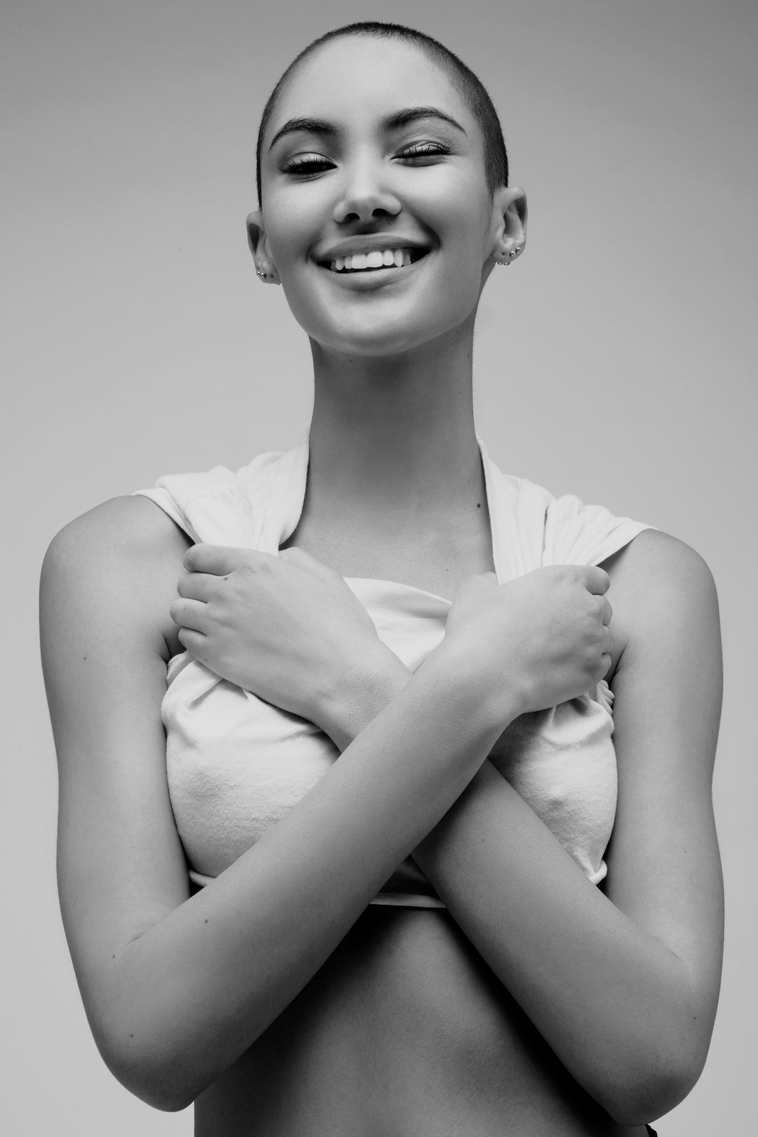 a black and white photo of a woman smiling