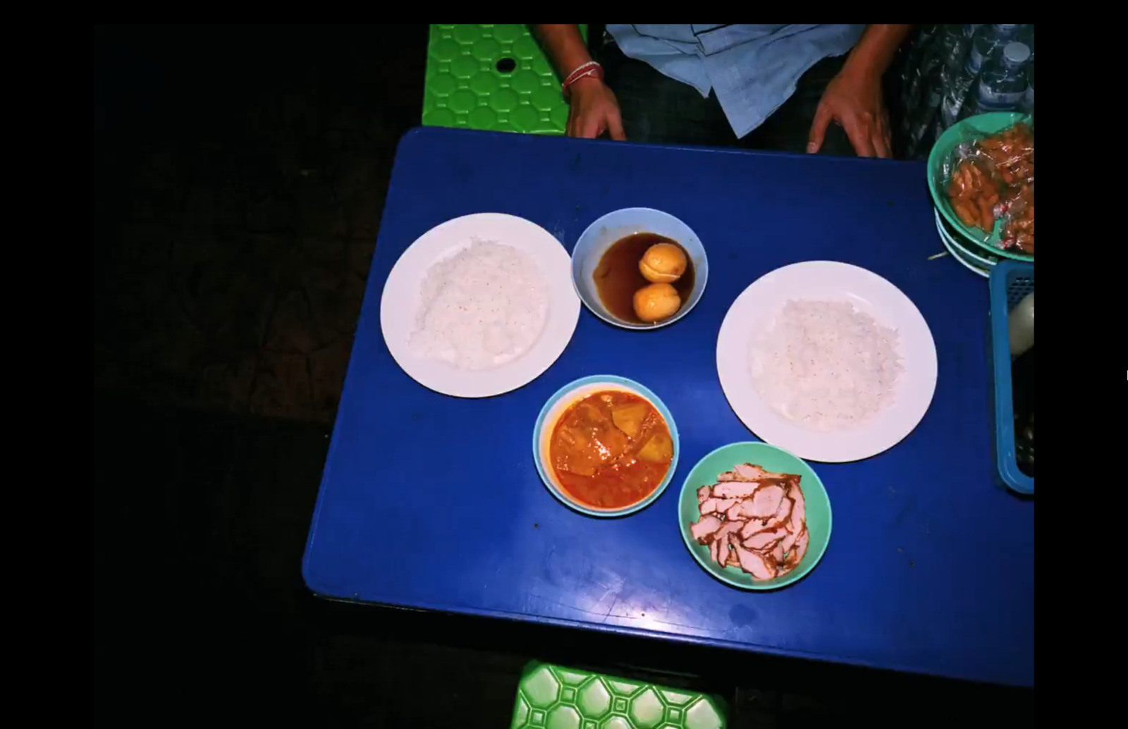 a blue table topped with bowls of food