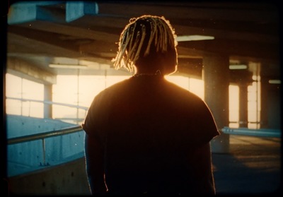 a person with dreadlocks standing in a building