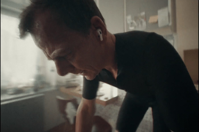 a man in a black shirt looking at a cell phone