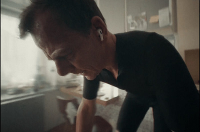 a man in a black shirt looking at a cell phone