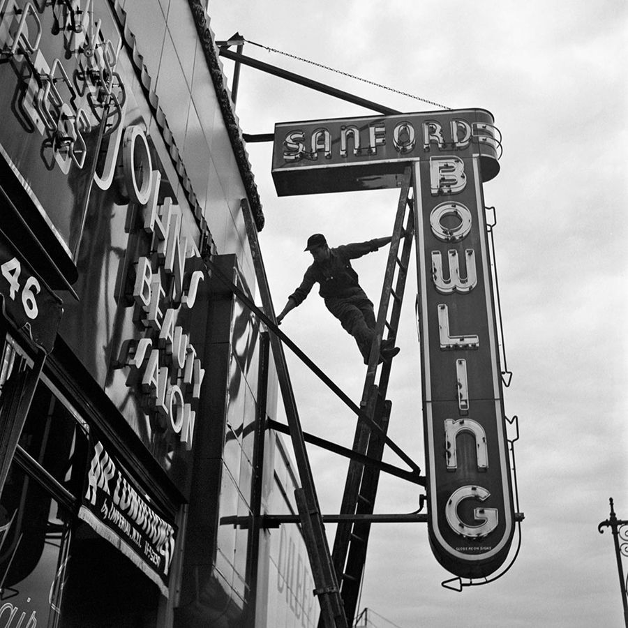 a black and white photo of a man on a sign