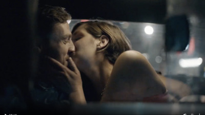 a man and a woman kissing in a car