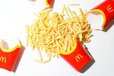 a pile of french fries sitting on top of a white table