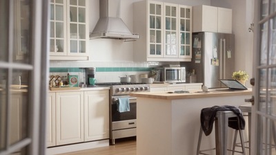 a kitchen with white cabinets and stainless steel appliances