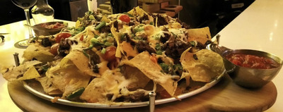 a platter of nachos and salsa on a table