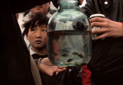 a person holding a jar filled with water